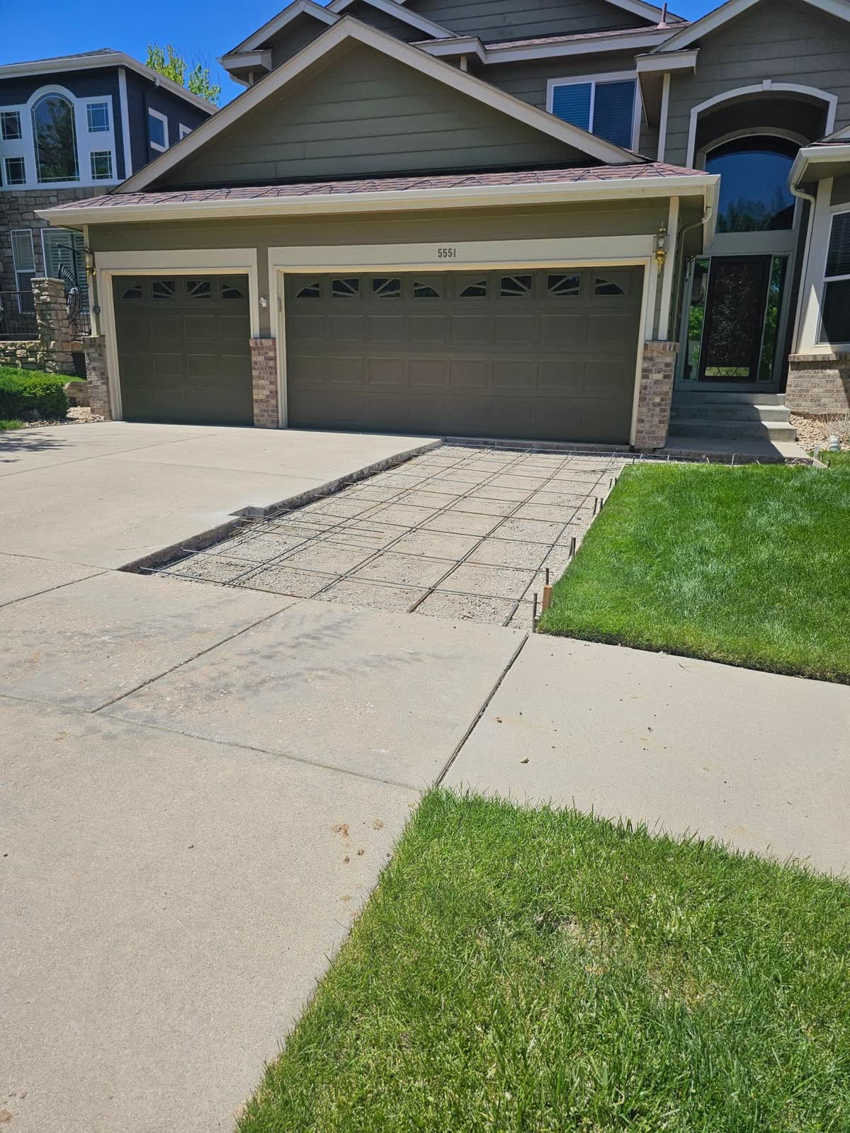 A replaced section of driveway poured flush with the old slab