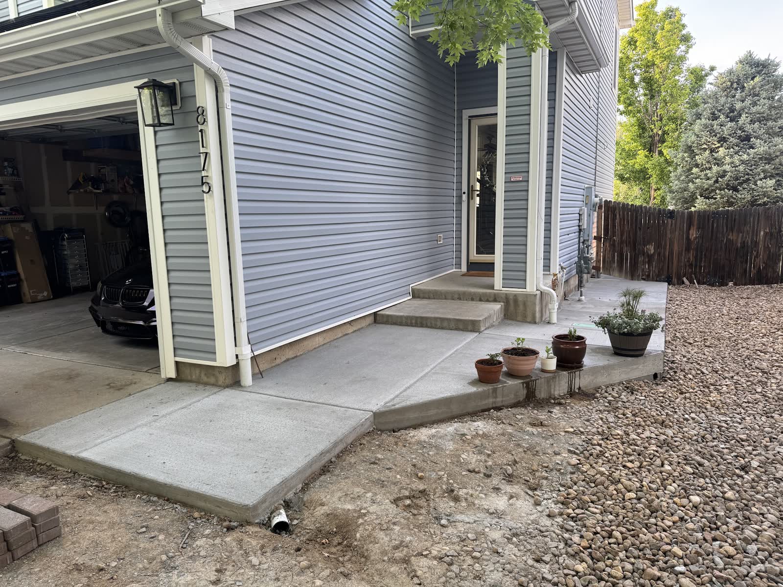 A new front porch pad and step at a blue house