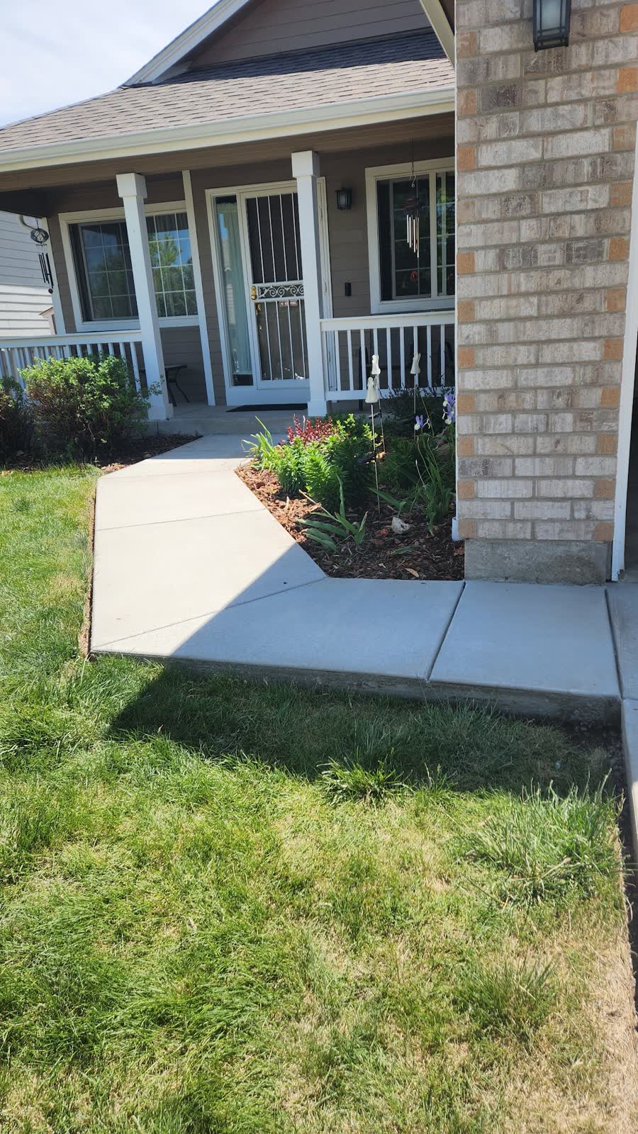 A new walkway turning a corner beside a flower bed