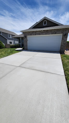 A finished driveway running up to a two-car garage, photographed by the customer