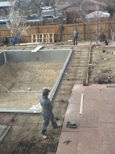 Gino's crew forming and setting rebar around a swimming pool for a new deck