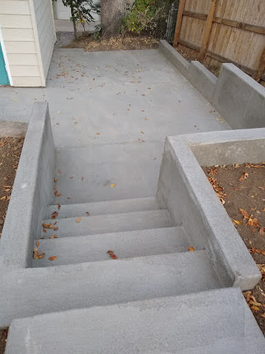 New steps and retaining walls leading down to a back patio