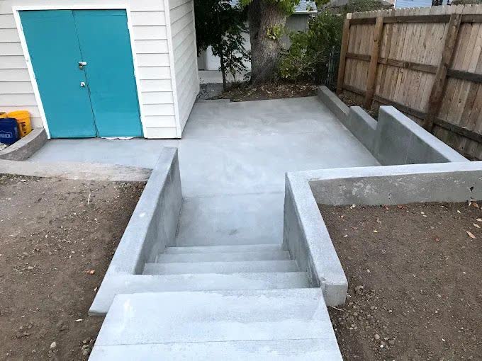 Concrete steps and a landing poured down to a back door